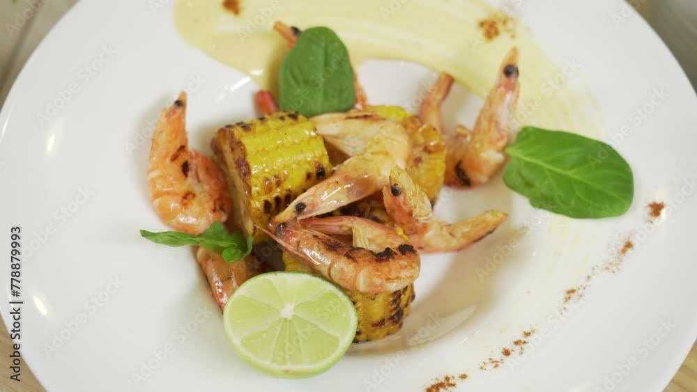 Serving grilled prawns and corn Serving grilled prawns and corn