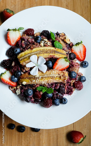 Oatmeal porrige and baked tripple berries oatmeal with banana apple cinnamon and berry and orange  photo