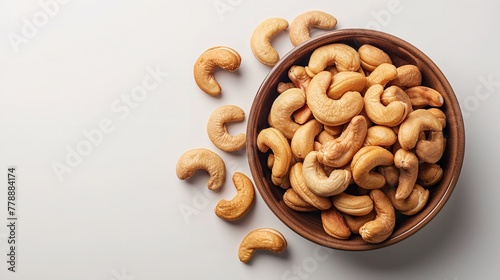 Top view of kaju or cashew nut in a bowl with a big space for text or product in a studio white backdrop, Generative AI. photo
