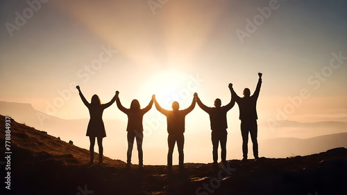 Success concept, Silhouette of a five people with arms raised up in the mountains at sunset © Artiroz