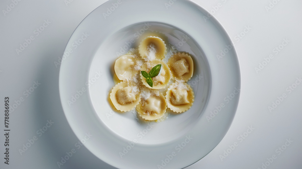 Elegant presentation of ravioli on a white plate, garnished with Parmesan and a basil leaf, in a bright, minimalist setting.
Elegant presentation of ravioli on a white plate, garnished with Parmesan and a basil leaf, in a bright, minimalist setting.