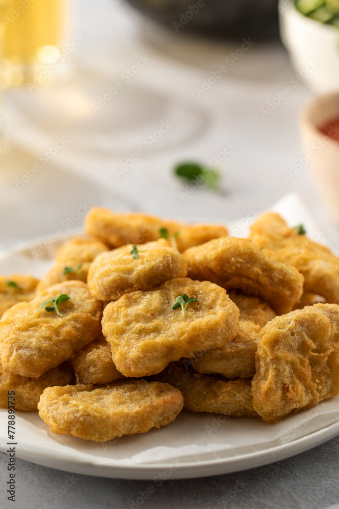 Delicious golden chicken nuggets on a plate close up. Fast food, menu. Delicious golden chicken nuggets on a plate close up. Fast food, menu.