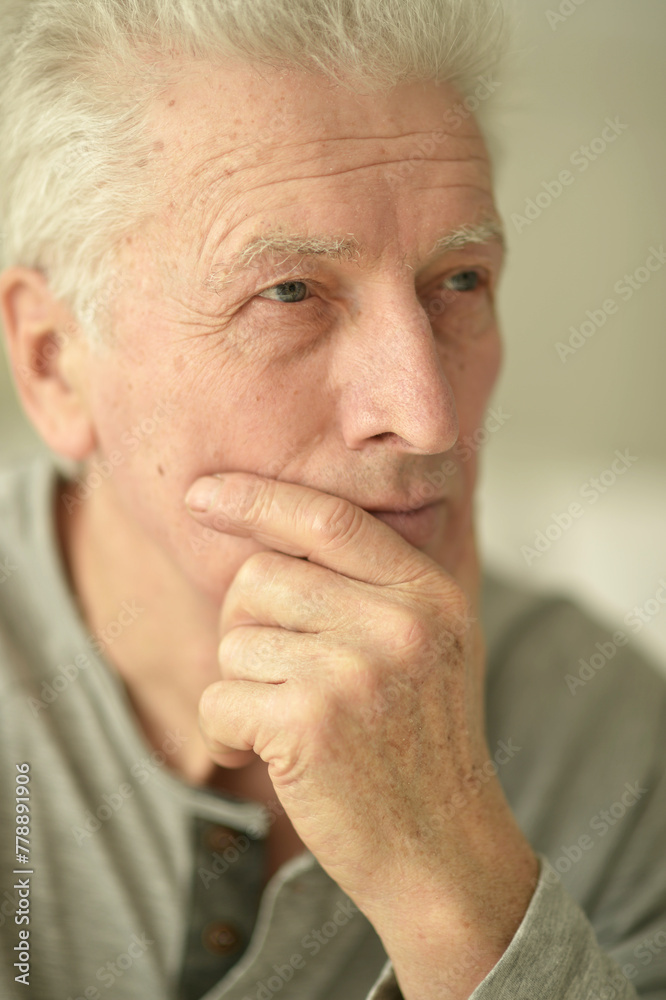 close-up portrait of a senior man thinking about something close-up portrait of a senior man thinking about something