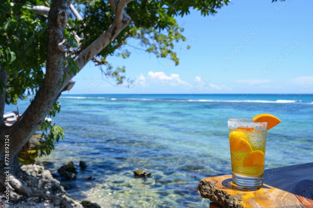 Obraz premium A vibrant beach scene with colorful summer cocktails resting on the sand, overlooking the azure sea