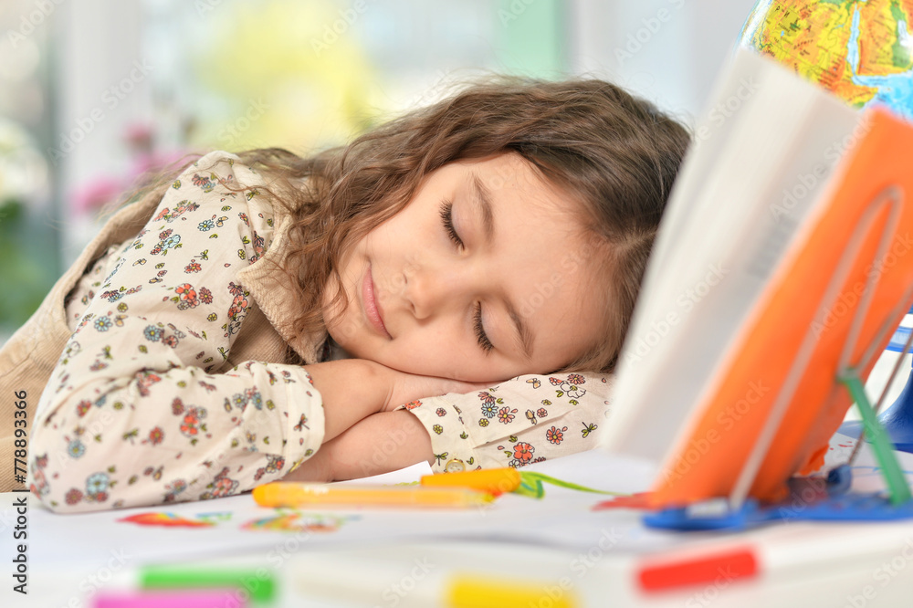 Portrait of cute schoolgirl sleeping on table Portrait of cute schoolgirl sleeping on table