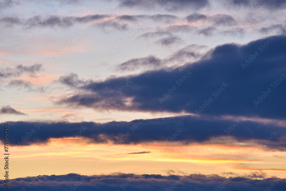 Evening sunset sky. Dark blue yellow clouds in the sky.