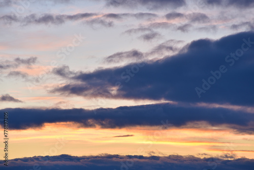 Evening sunset sky. Dark blue yellow clouds in the sky. © Lushchikov Valeriy