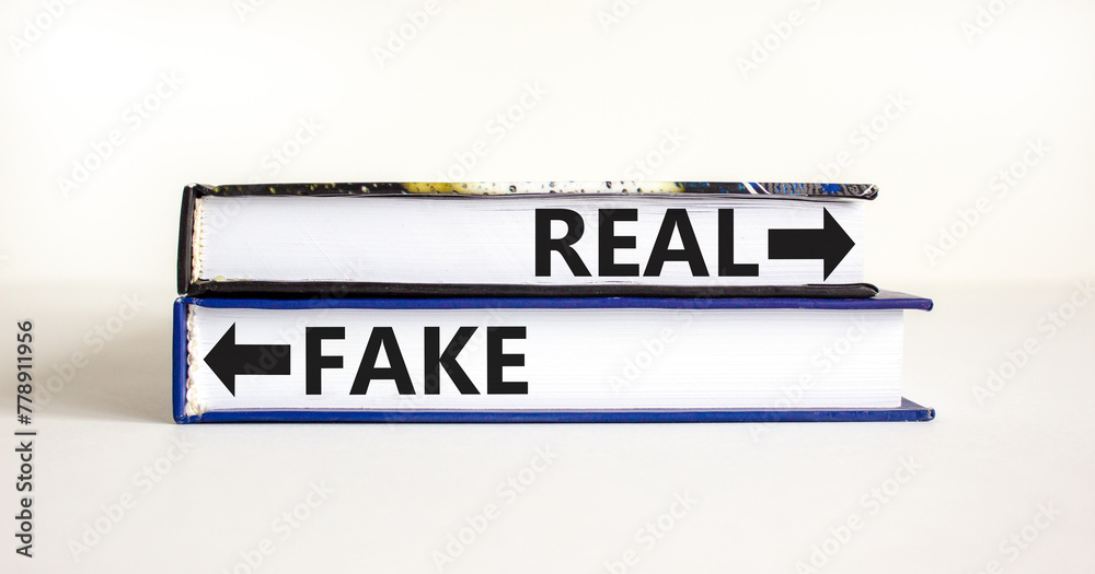 Real or fake symbol. Concept word Real or Fake on beautiful books. Beautiful white table white background. Business and real or fake concept. Copy space.