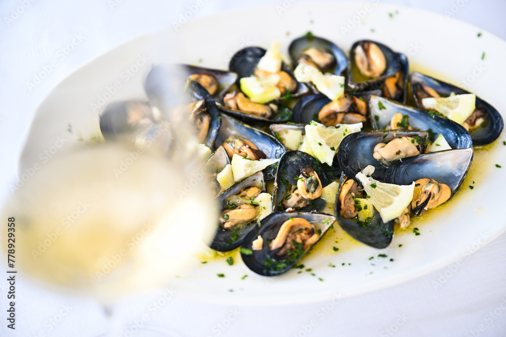 Ancona Marche Cozze di Portonovo or cozze del Conero called Moscioli whit marinara sauce with garlic parsley and chilli pepper and Verdicchio wine Ancona Marche Cozze di Portonovo or cozze del Conero called Moscioli whit marinara sauce with garlic parsley and chilli pepper and Verdicchio wine