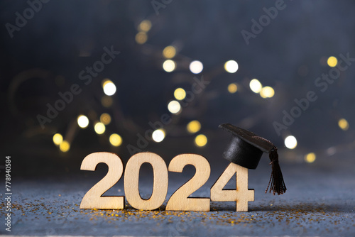 Class of 2024 concept. Number 2024 with graduated cap and bokeh lights. © Alina