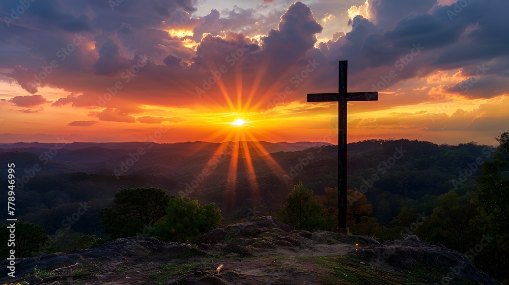 Hilltop cross in silhouette against colorful sunset vista