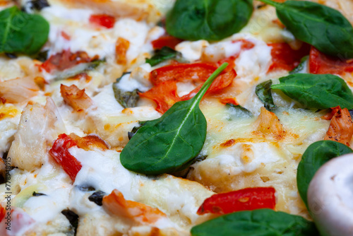 Pizza with spinach, cherry tomatoes and gorgonzola cheese on a light background
