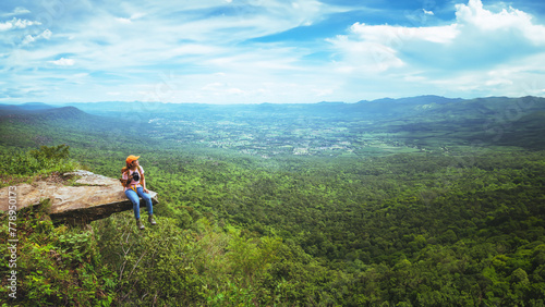 women asians travel relax in the holiday. Sit Take a photo on the cliff. photo