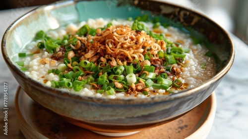 Rice porridge with pork and green onions in a ceramic bowl