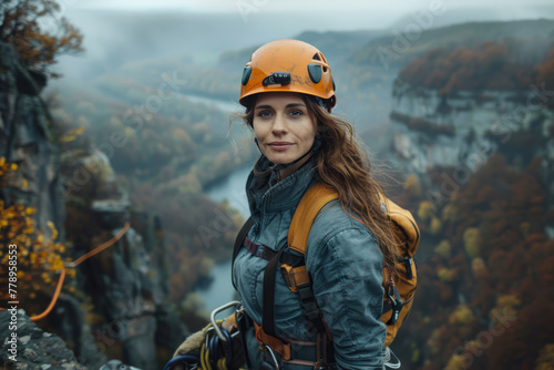 Girl climber travels through the mountainous terrain with a backpack and equipment