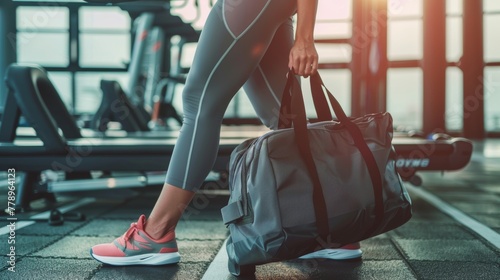 fit sporty woman in sportswear with gym bag wearing toned yoga pants and sneakers getting ready for exercise session at gym, lifestyle, fitness, healthy, fit, workout, jogger photo