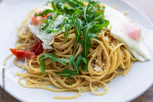 Italian spaghetti del poverello (Poor Man's Spaghetti), spaghetti pasta mixed with a lightly fried egg. Egg and cheese pasta, healthy food