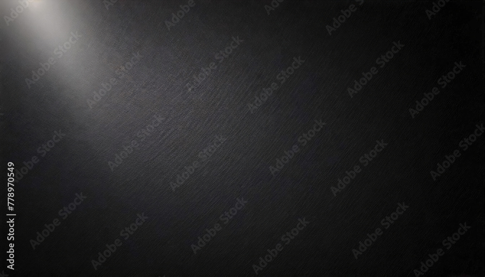 Open space on a black wall with a narrow beam of light from top left Open space on a black wall with a narrow beam of light from top left