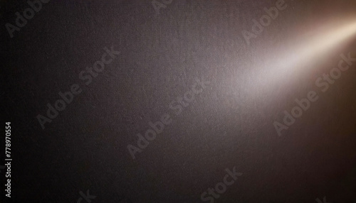 Brown textured wall with a ray of light shining from top left