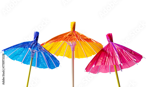 3 colorful cocktail umbrella popping out of the ground  white background