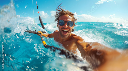 Happy man doing water sports on the beach. Kitesurfing.