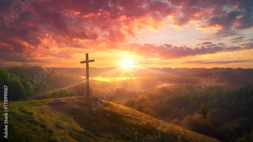 Cross standing on hill, surrounded by breathtaking sunset colors