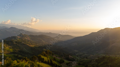 Aerial view of mountain and beautiful landscape sunset with .golden sunlight.
