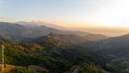 Aerial view of mountain and beautiful landscape sunset with .golden sunlight.