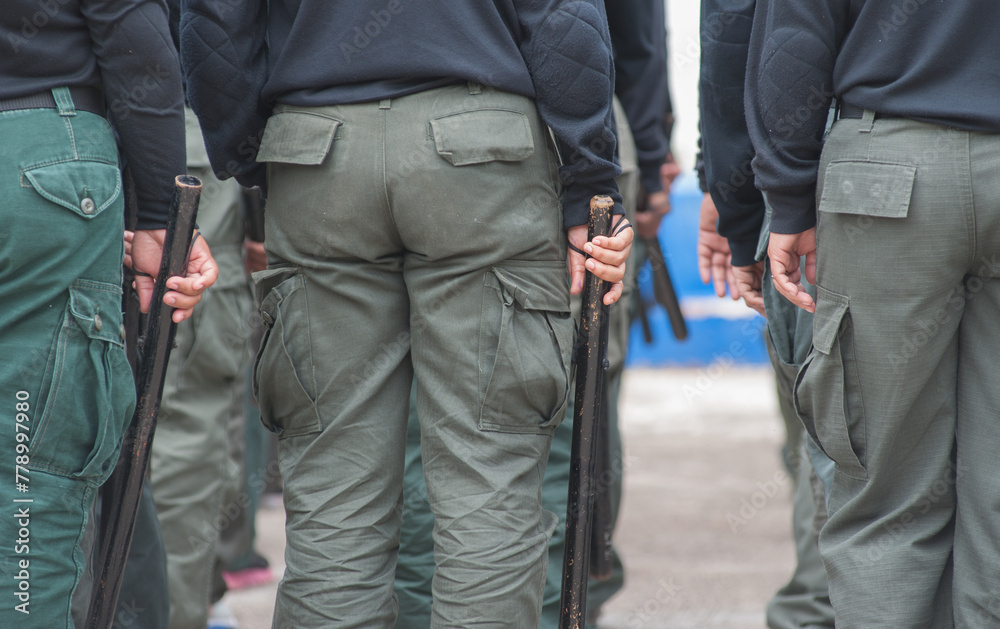 Female riot police practice using batons to control crowds.
