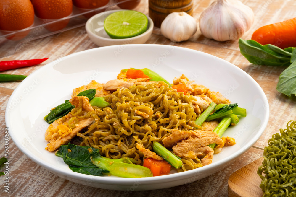 Stir fried instant Japanese style vegetable noodles with Soy Sauce and chicken breast in white plate.Asian food with low calories and healthy food.Thai style Stir fried instant Japanese style vegetable noodles with Soy Sauce and chicken breast in white plate.Asian food with low calories and healthy food.Thai style