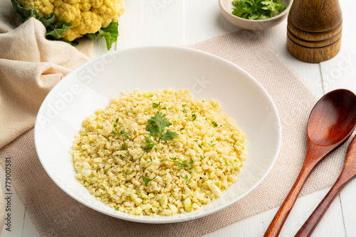Cauliflower rice in white plate.Low carb diet, healthy eating and low calories food.