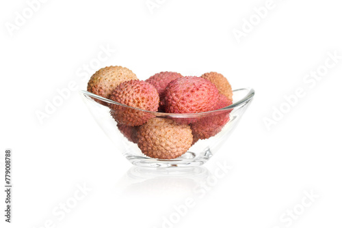 Lychee fruits on a white background in a glass bowl
