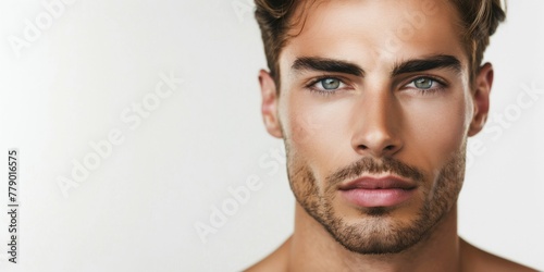 Close-up portrait, a satisfied young man after salon. The attractive brunette guy is seen with smooth skin. His model face features a modern haircut, embodying male cosmetic and beauty concept. photo