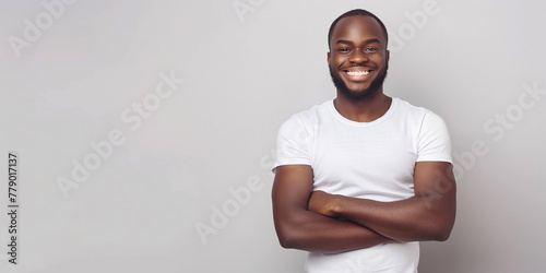 Photo of a happy, pumped-up black guy in a white T-shirt with copy space on the left, advertising banner