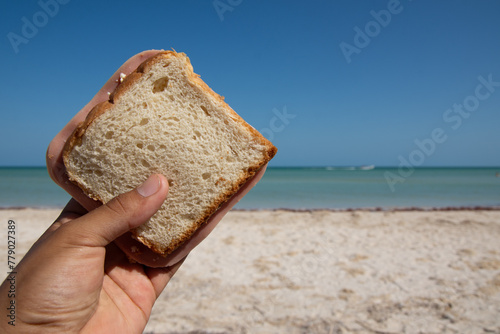Eating sandwich on the beach of Sisal