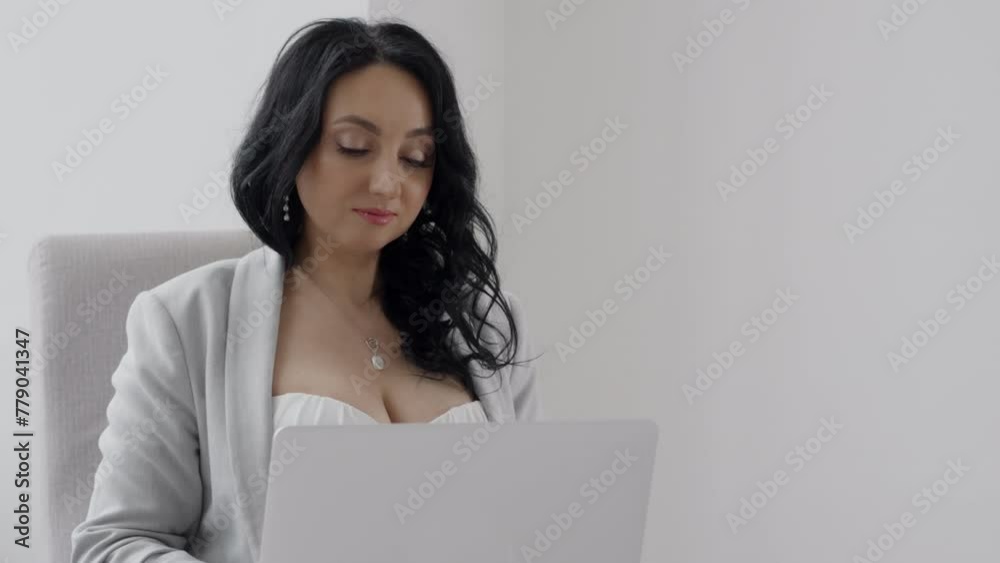 Woman working on laptop, sitting in chair, business woman sitting in office, working remotely on laptop, checking email to study online work at home. Woman working on laptop, sitting in chair, business woman sitting in office, working remotely on laptop, checking email to study online work at home.