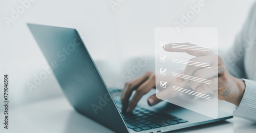 Business performance checklist, businessman using laptop doing online checklist survey, filling out digital form checklist, take an assessment, questionnaire, evaluation, online survey, online exam.