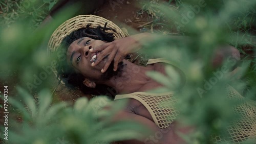 Man Smoking Weed while laying on the ground photo