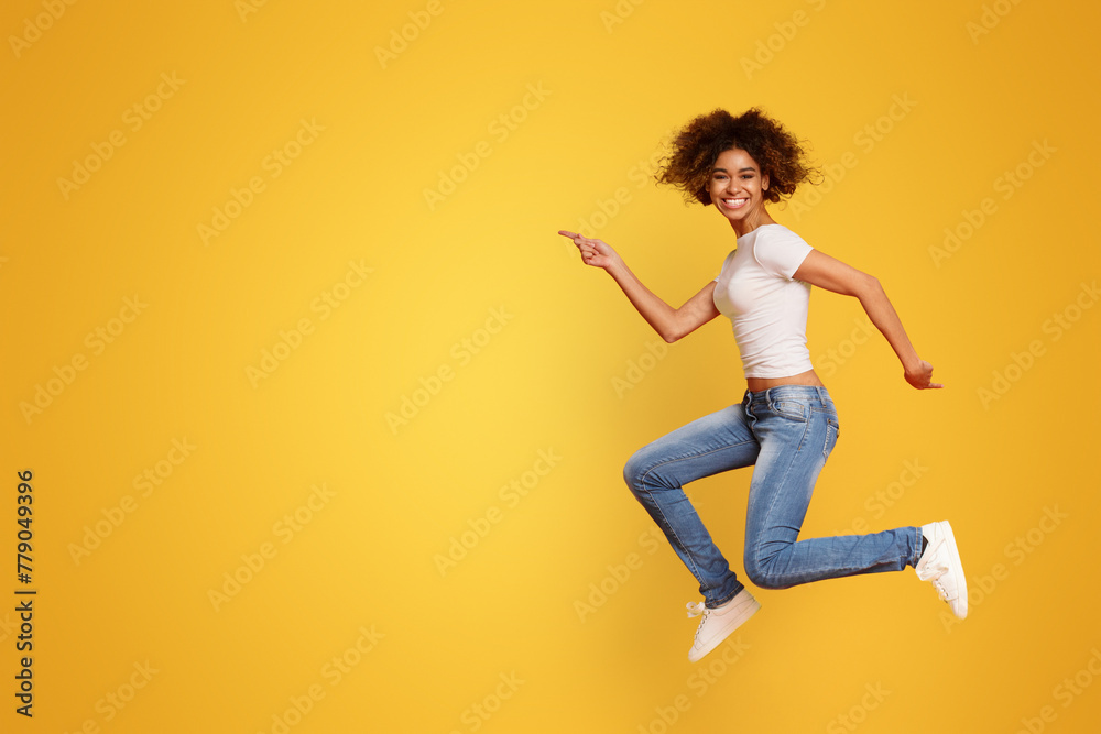 Funny portrait on young african american woman in humorous jump Funny portrait on young african american woman in humorous jump