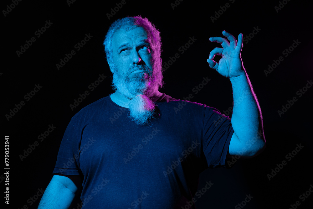 A contemplative man with a hand gesture as if holding something, under neon blue and pink lighting A contemplative man with a hand gesture as if holding something, under neon blue and pink lighting