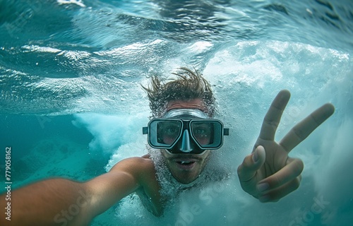 Selfie with a camera showing a young man diving beneath a large wave in the ocean