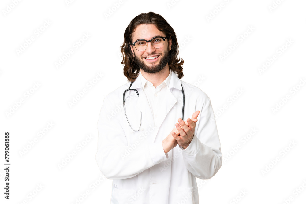 Young handsome man over isolated chroma key background wearing a doctor gown and applauding Young handsome man over isolated chroma key background wearing a doctor gown and applauding