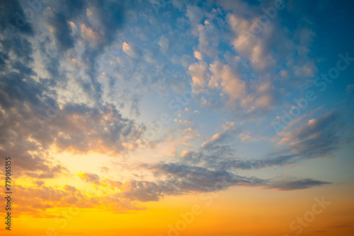 Vibrant gorgeous sunset sky with clouds background.