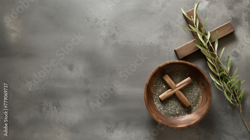 Ash Wednesday, faith, liturgy, religious ceremony background. Wooden cross, ceremonial dish with ash and olive branch on gray background