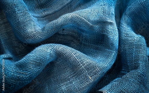 Elegant waves of blue netting material with intricate textures, ideal for background or design elements in creative projects. Burlap fabric texture - background