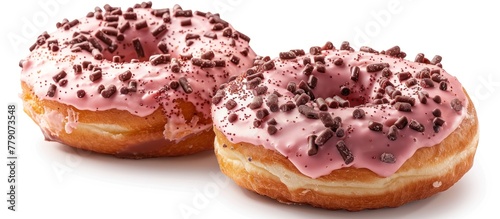 Two delicious donuts with pink frosting and chocolate sprinkles are displayed.
