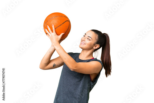 Young beauty woman over isolated chroma key background playing basketball