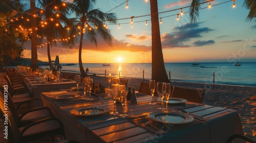 Decorated table at the beach resort in sunset time near the sea and sand for wedding and party events celebrations