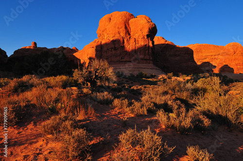 Late afternoon sunlight on sandstone formations near the Double Arch, Arches National Park, Moab, Utah, Southwest USA.