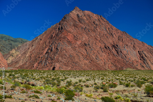 A red, pyramid-shaped peak on the scenic, winding road through the beautiful landscape of the Quebrada Las Angosturas to the Paso de San Francisco mountain pass, Catamarca Province, Argentina. photo